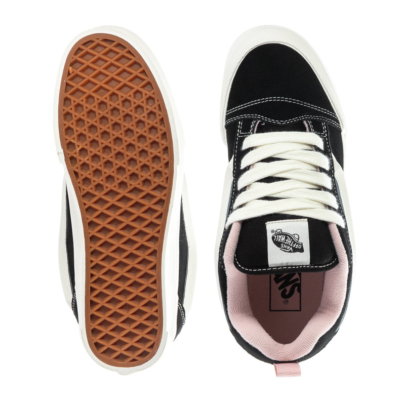 Black low-top sneaker outsole and toe, white rubber sole and pink interior lining.
