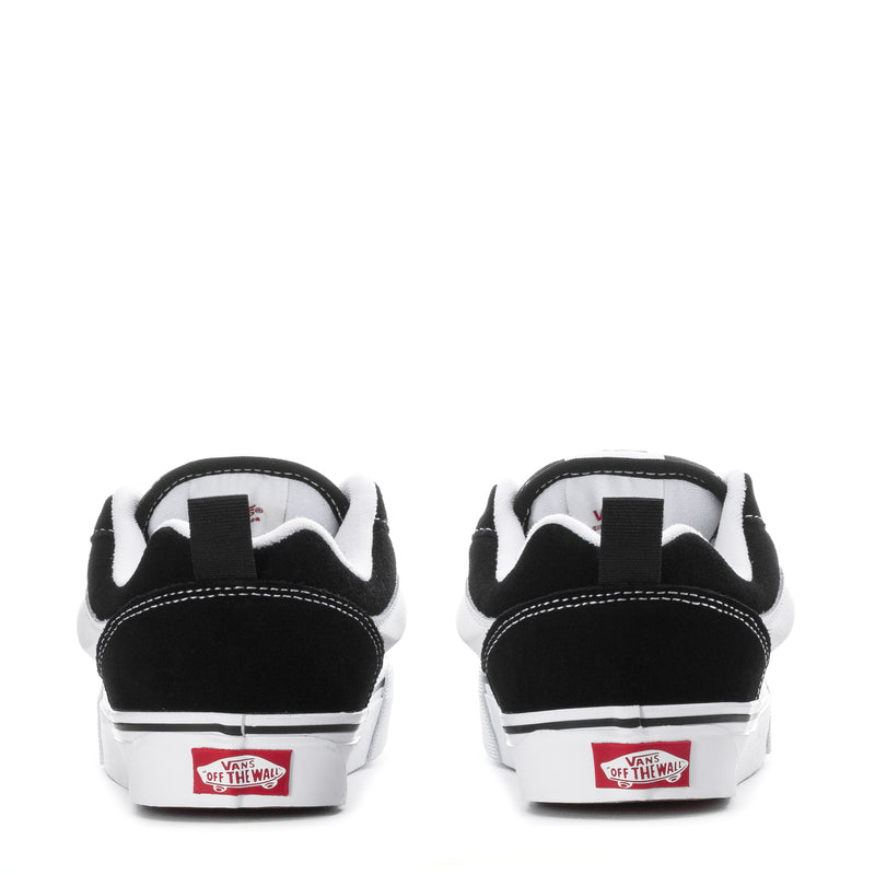 Black and white sneaker heel view with cushioned collar and white rubber midsole