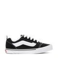 Black and white youth lace-up sneakers with wavy side stripe and white midsole.