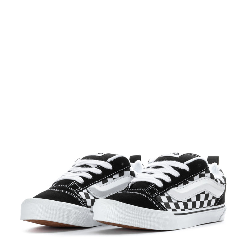Youth checkerboard low-top sneakers, front view with white laces and black toe caps