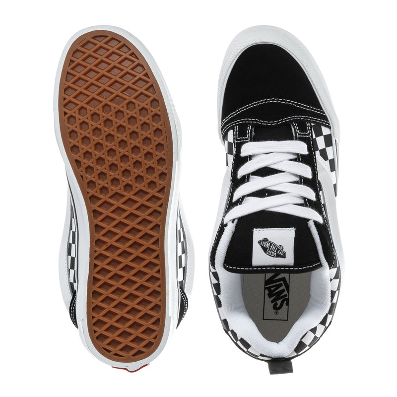 Youth low-top sneakers, black uppers with checkerboard trim; visible outsole and tongue tag