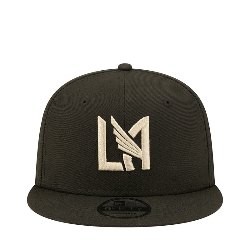 Dark baseball cap with white and gold LA-style monogram logo on front