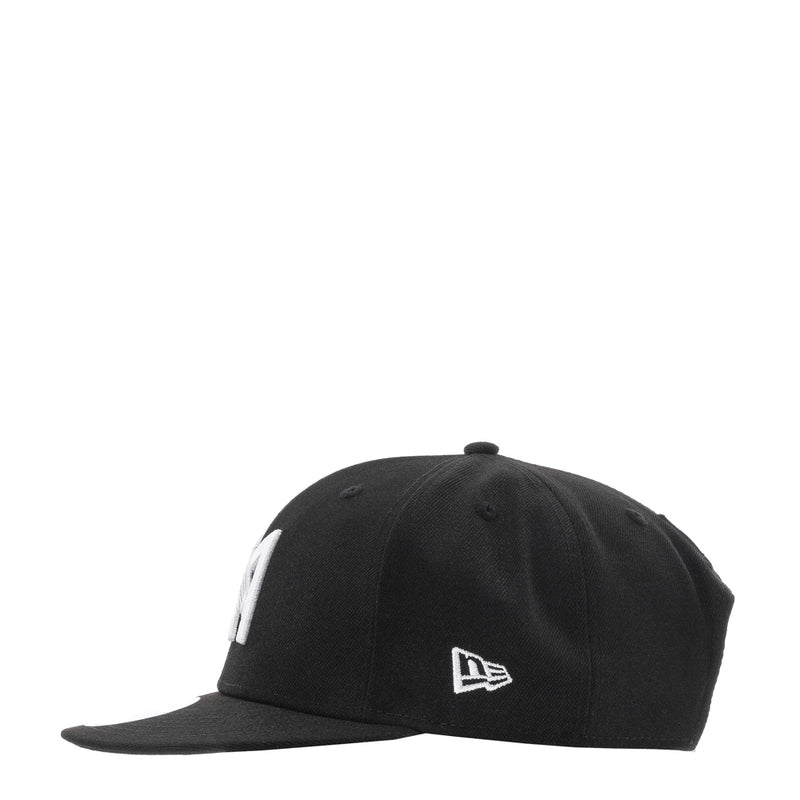Black baseball cap with white side emblem and curved brim