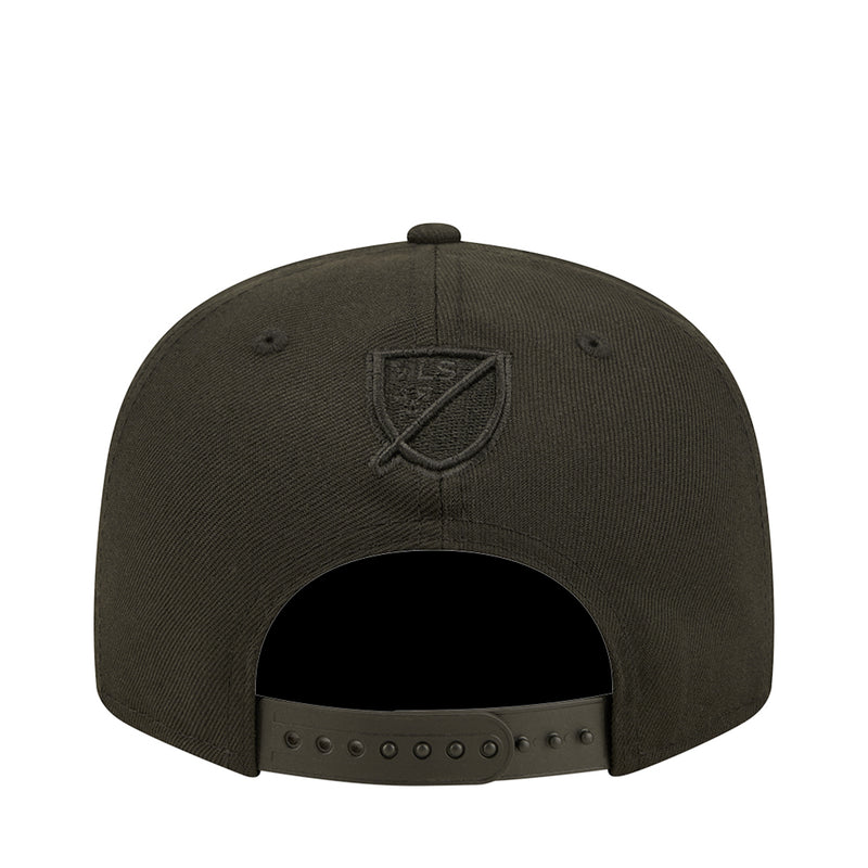 Dark baseball cap with embroidered shield crest logo on back