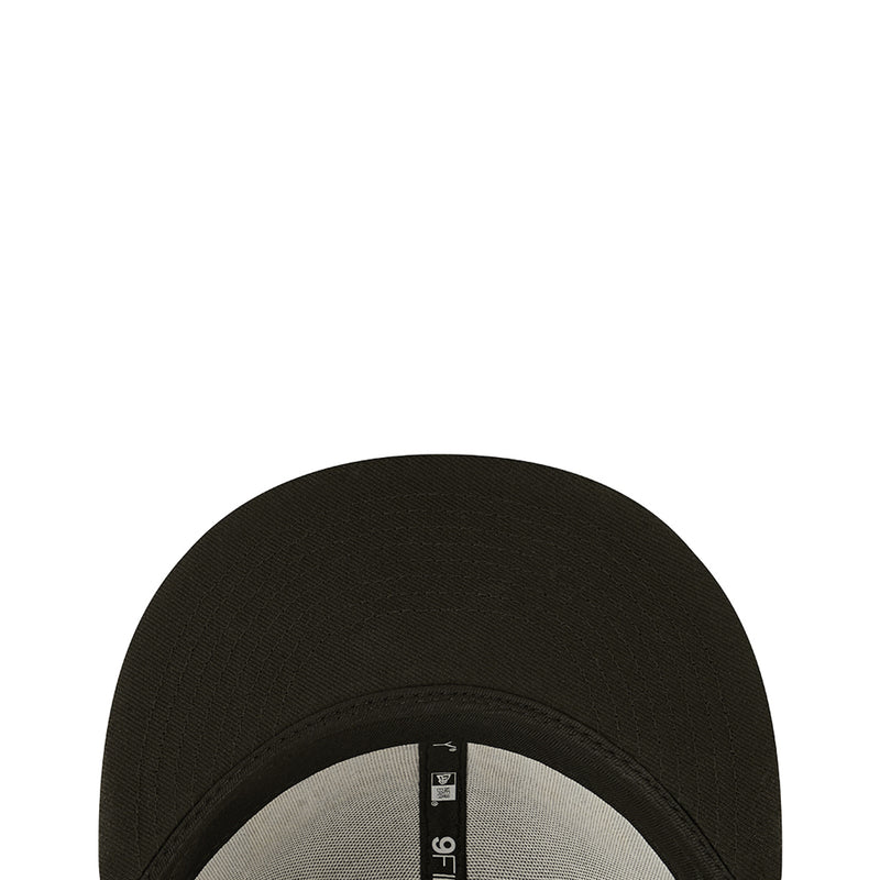 Dark baseball cap top view showing textured fabric and stitched crown seam