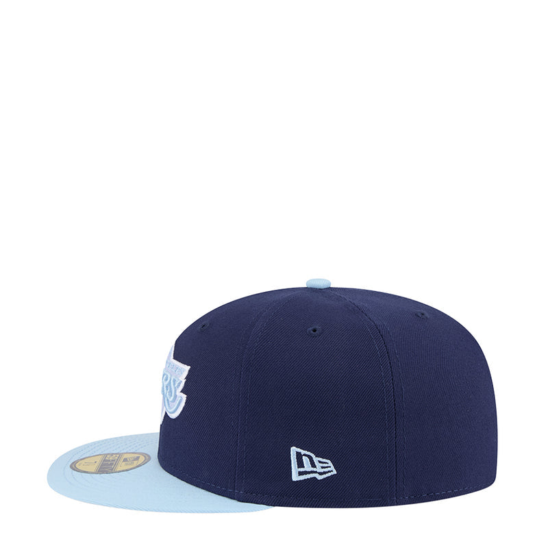 Two-tone baseball cap, dark navy crown with light blue brim and New Era logo