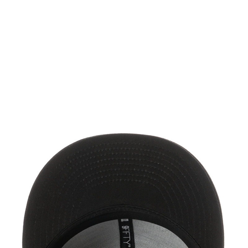 Black cap brim underside with patterned stitching and perforation detail
