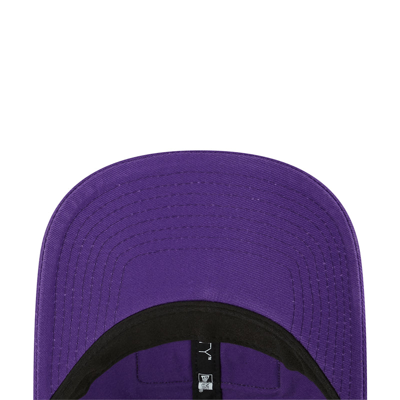 Purple trucker cap close-up with curved seams and black interior band