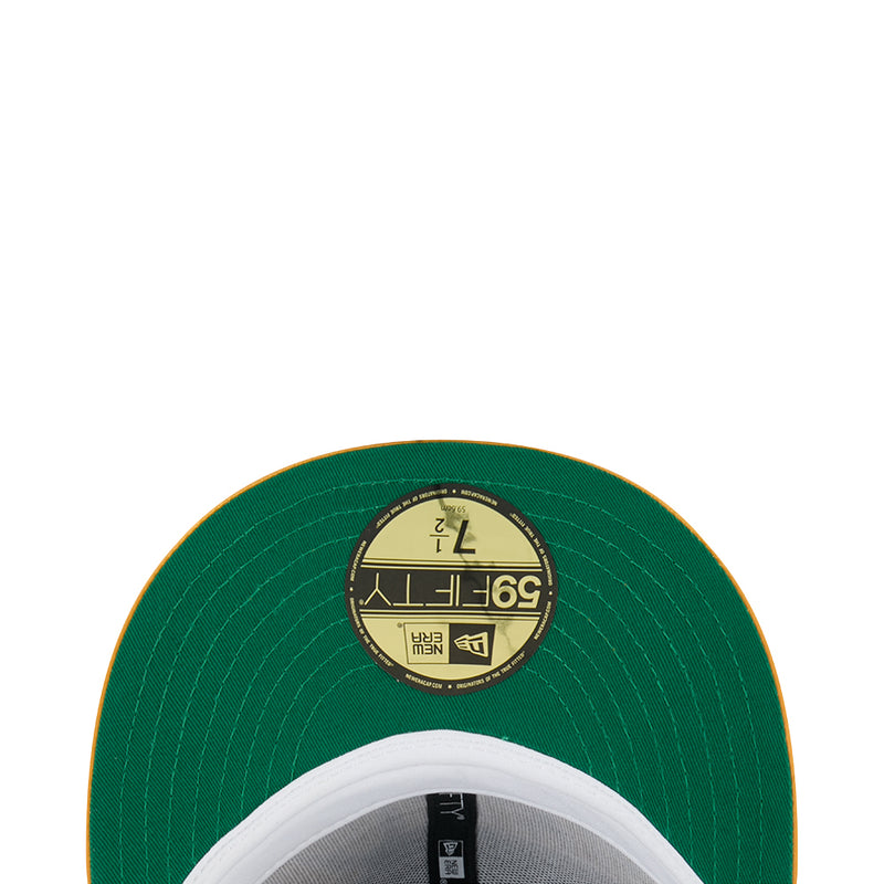 Green cap underside with circular interior label and stitched brim edge