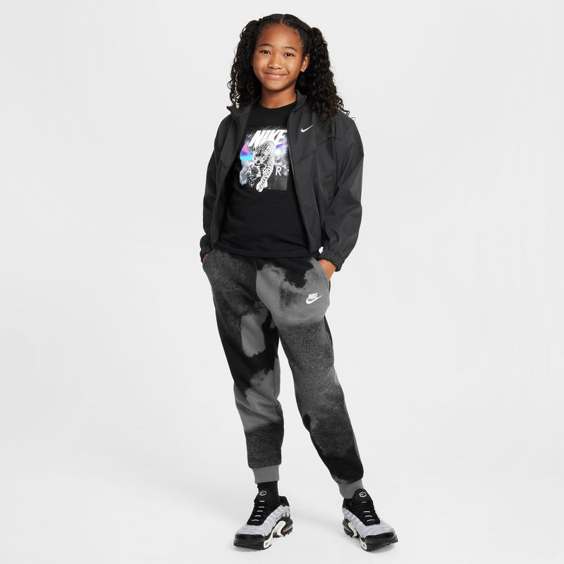 Black youth T-shirt with NIKE leopard photo print peeking under a jacket.