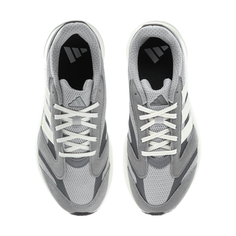 Grey sneakers with white laces, three stripe accents, and black interior lining