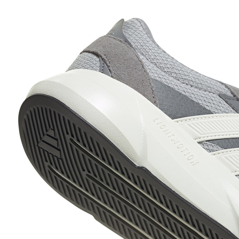 Grey sneaker side close-up with white midsole and black tread outsole