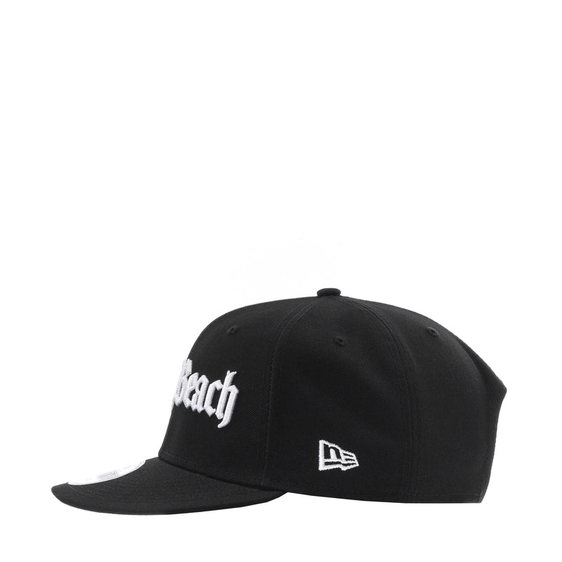 Black snapback cap with white 'Beach' lettering and New Era side logo