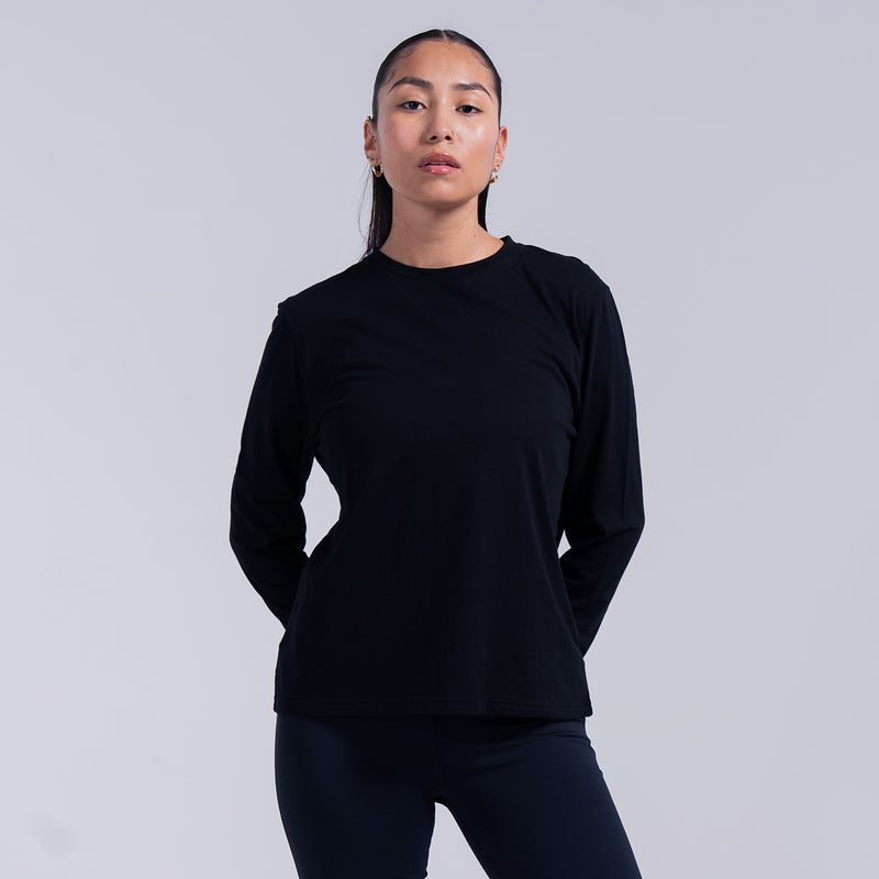 Women's black long-sleeve crewneck tee on model