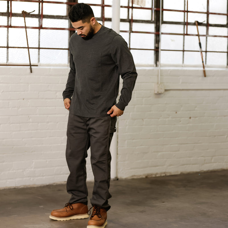 Charcoal grey long-sleeve crew neck work shirt, side view on model