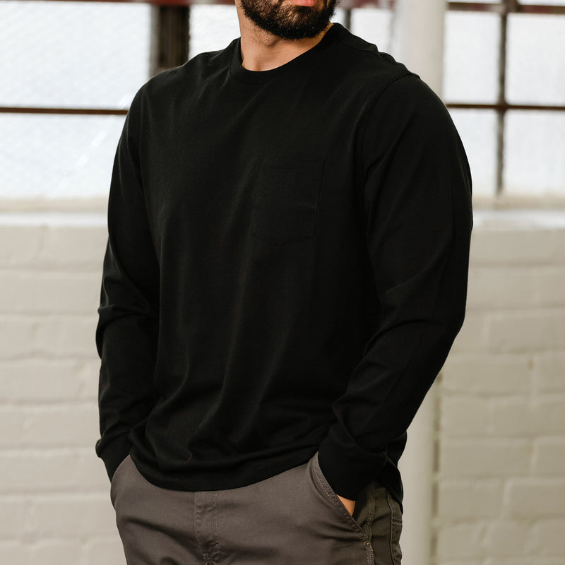 Men's black long-sleeve work shirt, side profile with ribbed cuffs
