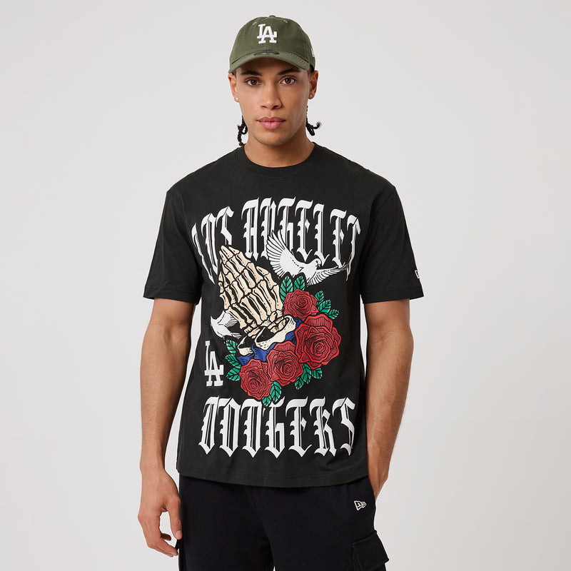 Black graphic T-shirt with gothic-style lettering, hand artwork, and red roses.