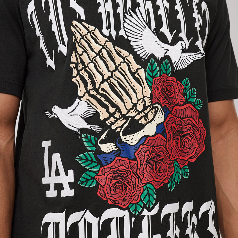 Black T-shirt close-up: gothic hand skull with red roses and green leaves print.