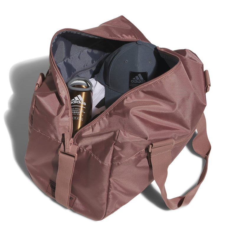 Open warm clay pink duffel bag with interior pocket and adidas water bottle