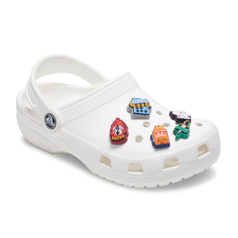 White clog with five colorful jibbitz charms including lotto and skull designs