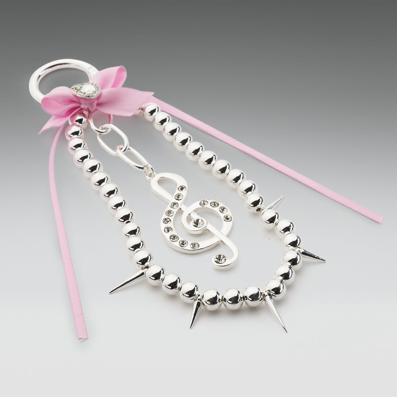 Silver beaded hair accessory with pink ribbon and decorative bow on a gray background