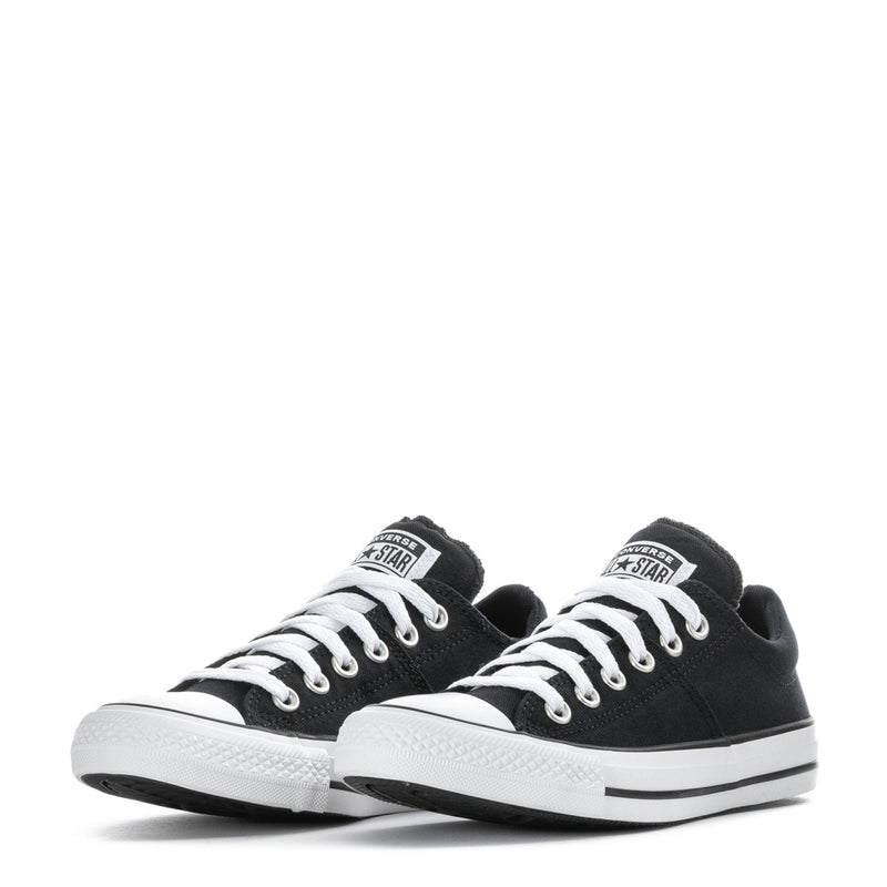 Pair of black low-top canvas sneakers with white laces and white toe caps