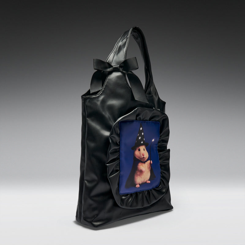 Black handbag with a pocket featuring a cartoon character on a gray background
