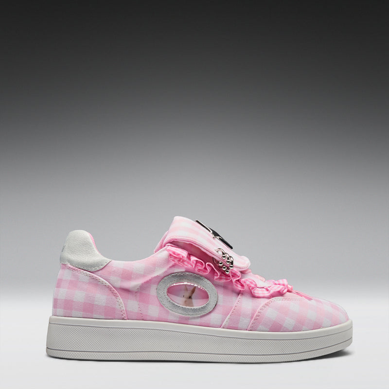 Pink checkered sneaker with decorative elements on a gray background