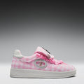 Pink checkered sneaker with decorative elements on a gray background