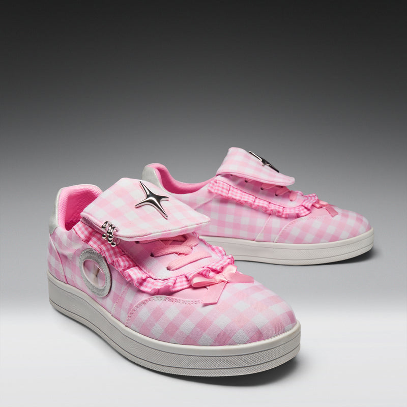 Pair of pink checkered sneakers with white soles on a gray background