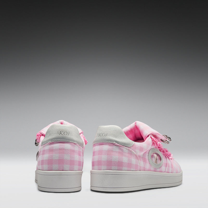 Pink checkered sneakers with white soles on a gray background