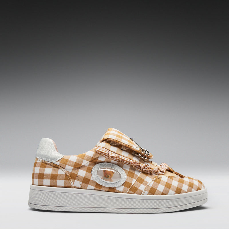 Checkered sneaker with decorative elements on a gray background