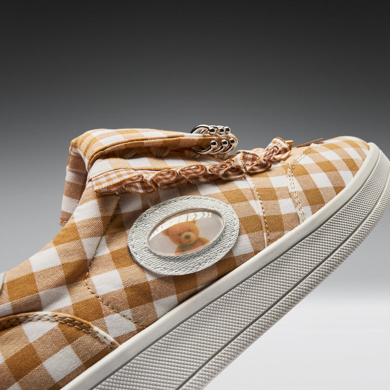 Checkered sneaker with decorative elements on a gradient background