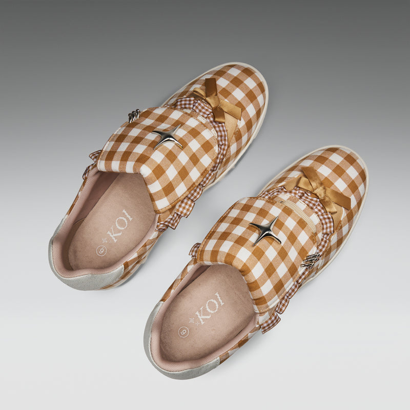 Pair of checkered loafers on a gradient background