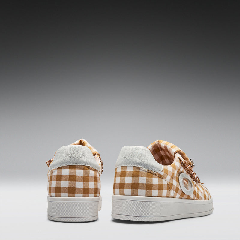 Pair of checkered sneakers on a gray background