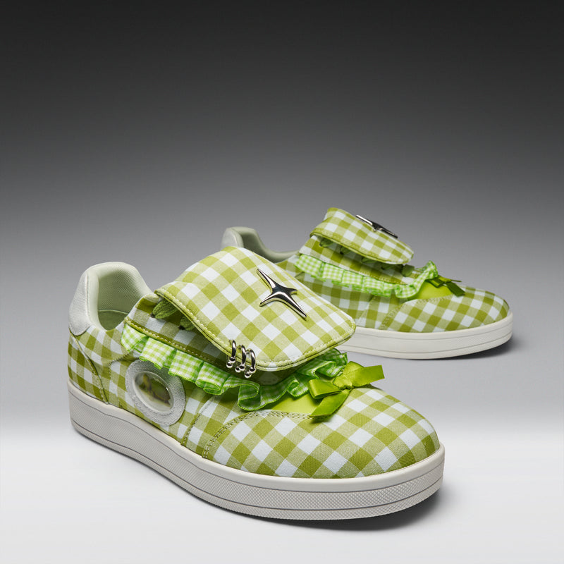 Green and white checkered shoes with bows on a gray background