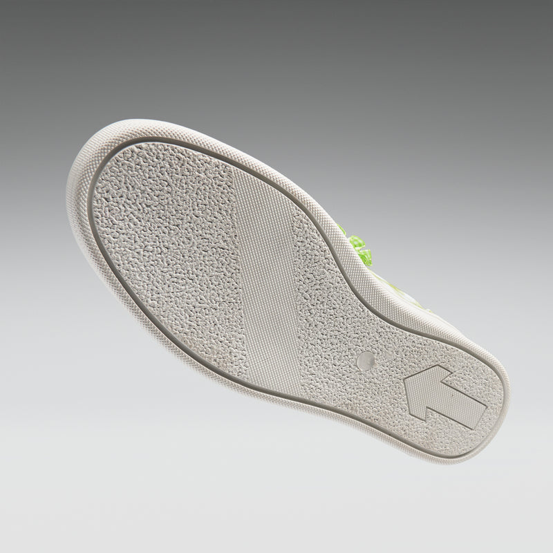 Close-up of a shoe sole with a brand logo on a gray background