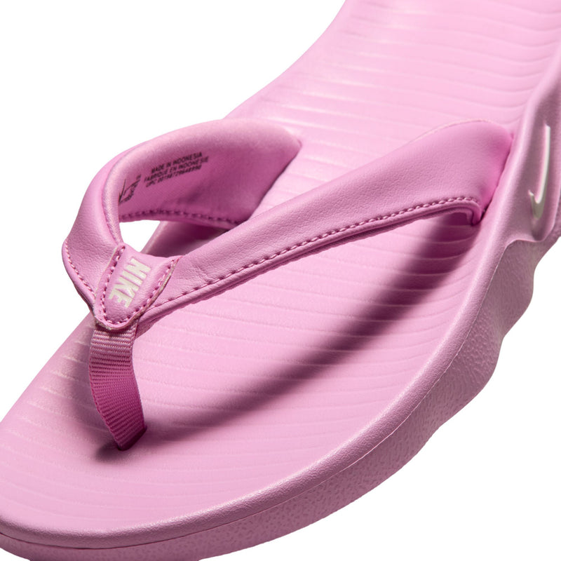 Close-up of light magenta thong sandal strap and textured footbed stitching