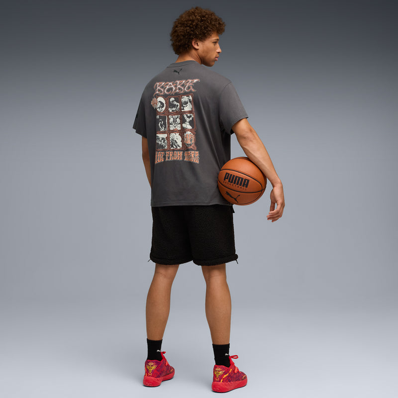 Mens red low-top sneakers with black socks, holding a basketball, rear/side view.