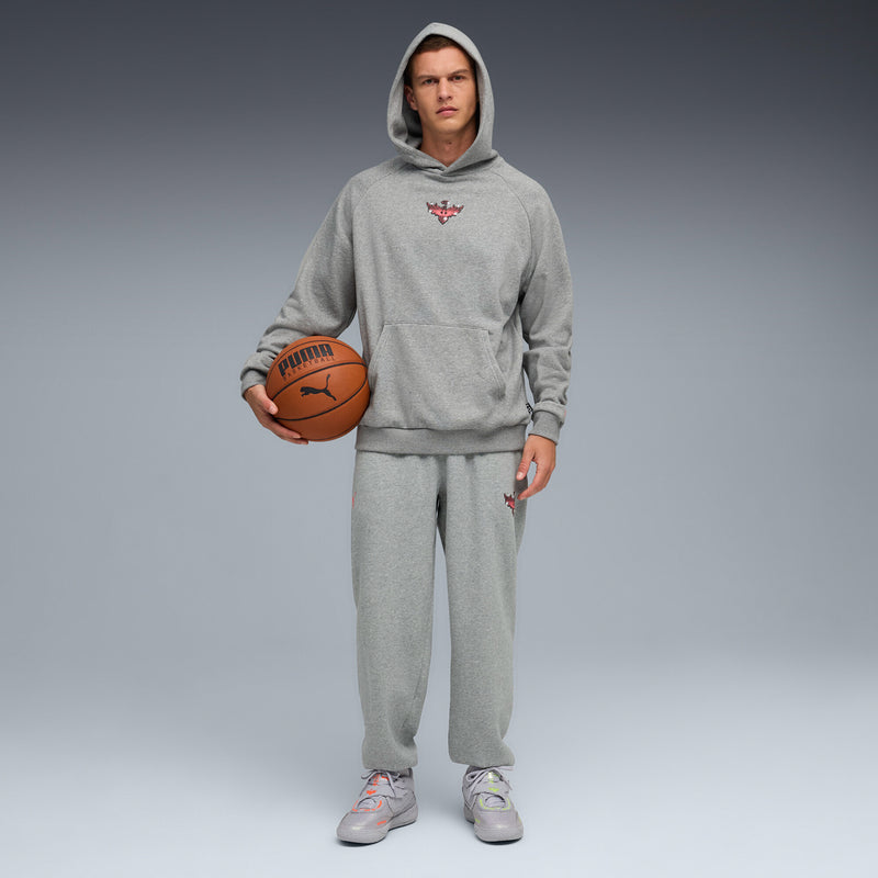 Men’s gray hoodie and joggers outfit with matching gray lace-up sneakers and orange ball
