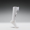 White knee-high socks with a bow on a gray background
