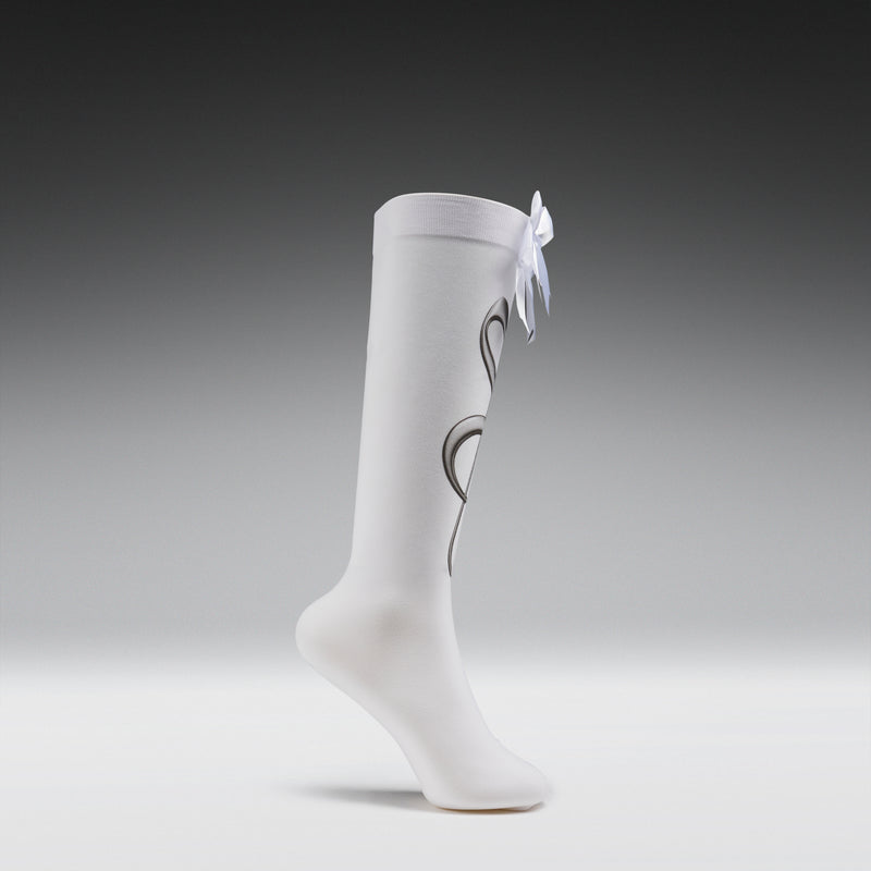 White knee-high socks with a bow on a gray background