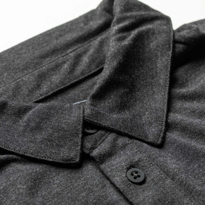 GORUCK men's black triblend polo shirt with pocket and black buttons, close-up view