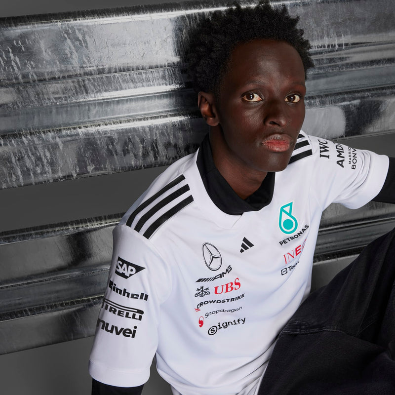 White replica football jersey with Mercedes emblem and PETRONAS text on the chest, trim.
