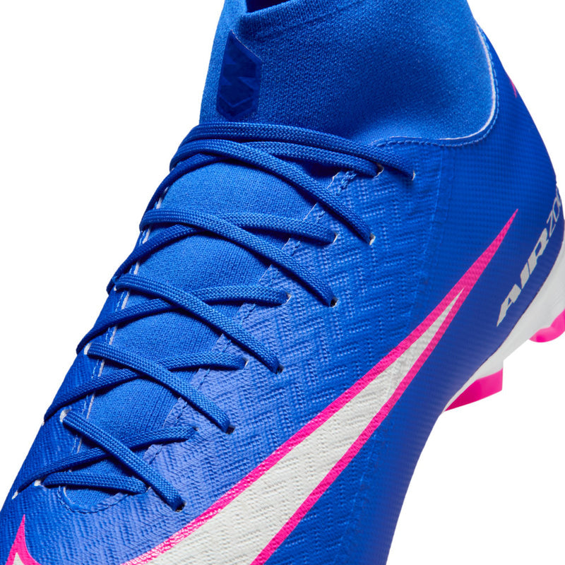 Close-up of blue lace-up soccer cleat with pink swoosh and white details on upper.