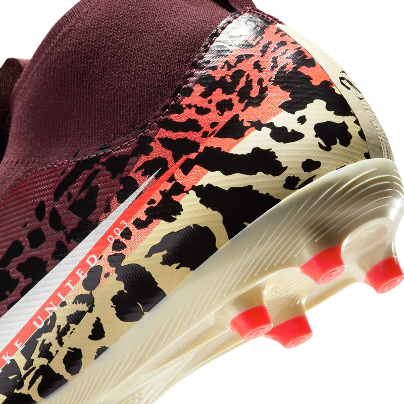 Close-up youth soccer cleat showing leopard print on side and translucent edge with studs.