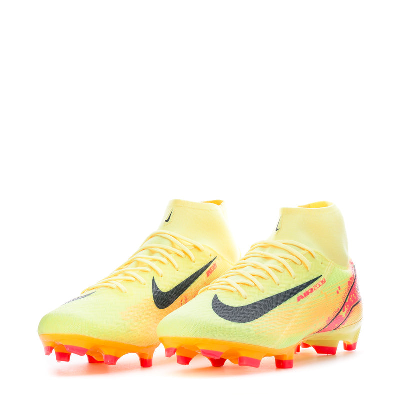 Pair of yellow soccer cleats, black swoosh, orange-red heel and studded sole