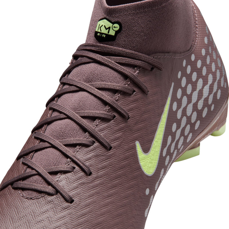 Close-up plum soccer cleat with neon green swoosh, laces, and KM heel tag