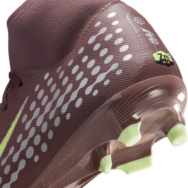 Close-up plum soccer cleat with white dot texture and neon green cleats