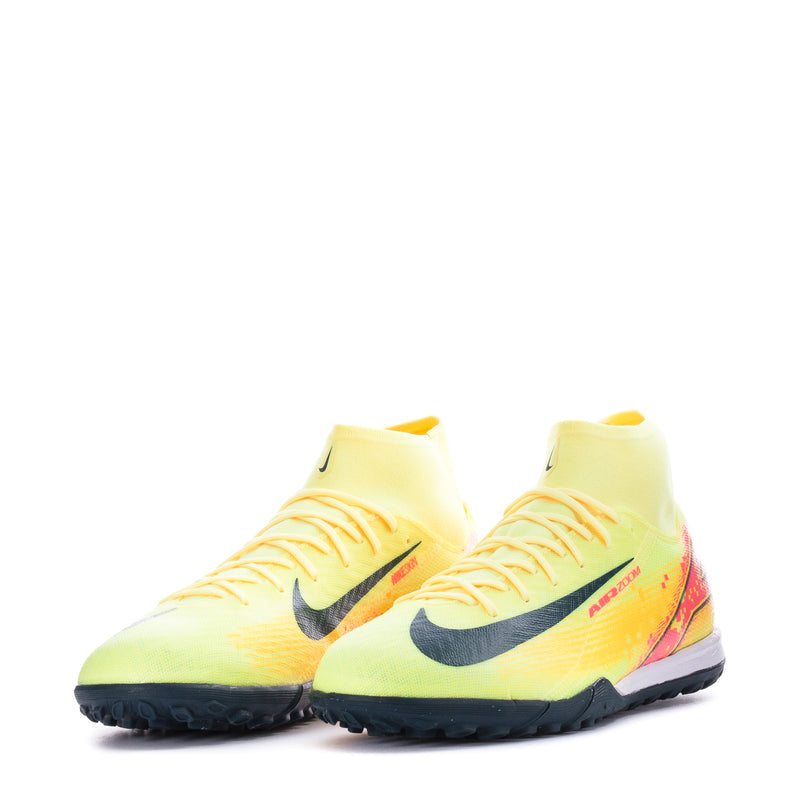 Pair of men's turf soccer cleats, light yellow with black swoosh and laced forefoot